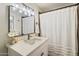 Cozy bathroom featuring a vanity with updated faucet and a shower with a curtain at 6005 N Granite Reef Rd, Scottsdale, AZ 85250