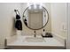 Modern bathroom features a round mirror, stylish faucet, and elegant countertop at 6005 N Granite Reef Rd, Scottsdale, AZ 85250