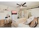 Comfortable bedroom with a ceiling fan, dresser, and a peek into the bathroom at 6005 N Granite Reef Rd, Scottsdale, AZ 85250