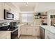 Bright kitchen features white cabinets, stainless steel appliances, and light countertops for a clean, modern feel at 6005 N Granite Reef Rd, Scottsdale, AZ 85250