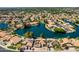 Overhead view of houses with solar panels, pools, and boats on the water for outdoor recreation at 608 E Stonebridge Dr, Gilbert, AZ 85234