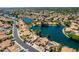Breathtaking aerial perspective showcasing a community nestled around a serene lake, complete with solar panels at 608 E Stonebridge Dr, Gilbert, AZ 85234