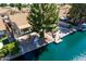 This backyard oasis has waterfront access and a lush green tree for shade at 608 E Stonebridge Dr, Gilbert, AZ 85234