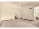 Large bedroom with neutral carpet, ceiling fan, and en-suite bathroom access at 608 E Stonebridge Dr, Gilbert, AZ 85234