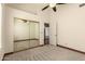 Bedroom showcasing neutral carpet, ceiling fan, closet doors, and natural light at 608 E Stonebridge Dr, Gilbert, AZ 85234