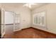 Bedroom with plantation shutters on the window and french doors at 608 E Stonebridge Dr, Gilbert, AZ 85234