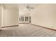 Bright bedroom featuring neutral carpet, ceiling fan, and multiple windows for ample natural light at 608 E Stonebridge Dr, Gilbert, AZ 85234