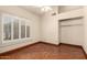 Bright bedroom featuring plantation shutters and a built-in closet at 608 E Stonebridge Dr, Gilbert, AZ 85234