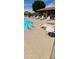 Relaxing community pool area with multiple lounge chairs and shade structures at 608 E Stonebridge Dr, Gilbert, AZ 85234