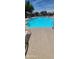 Large sparkling community pool with lounge chairs and shade umbrellas for residents to enjoy at 608 E Stonebridge Dr, Gilbert, AZ 85234