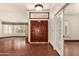 Inviting foyer with hardwood floors, rich wood double doors and sidelight, plus a view to the adjacent living area at 608 E Stonebridge Dr, Gilbert, AZ 85234