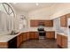 Bright kitchen features wood cabinets, white countertops, stainless appliances, and tile flooring at 608 E Stonebridge Dr, Gilbert, AZ 85234