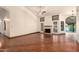 Spacious living room with fireplace and scenic lake view from sliding glass doors at 608 E Stonebridge Dr, Gilbert, AZ 85234