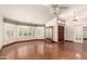 Living room featuring plantation shutters and a glass display case at 608 E Stonebridge Dr, Gilbert, AZ 85234