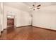 Spacious living room with a ceiling fan and double doors upon entry to the home at 608 E Stonebridge Dr, Gilbert, AZ 85234
