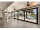 Spacious sunroom with waterfront views, tiled floor, and ceiling fans for comfortable indoor/outdoor living at 608 E Stonebridge Dr, Gilbert, AZ 85234