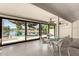 Bright sunroom featuring large windows, lake views, and a dining area for relaxing and entertaining at 608 E Stonebridge Dr, Gilbert, AZ 85234