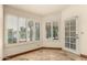 Bright sunroom with shuttered windows offering picturesque views of the serene lake at 608 E Stonebridge Dr, Gilbert, AZ 85234