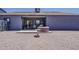 View of the backyard with a patio, hot tub, and desert landscaping, perfect for relaxation at 6154 S Borego Rd, Gold Canyon, AZ 85118
