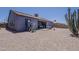 Desert landscaped backyard with a covered patio and hot tub, great for outdoor living at 6154 S Borego Rd, Gold Canyon, AZ 85118