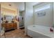 Bright bathroom with a double sink vanity, separate shower, and soaking tub at 6154 S Borego Rd, Gold Canyon, AZ 85118