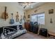 Bedroom featuring a ceiling fan, natural lighting, and guitar decor at 6154 S Borego Rd, Gold Canyon, AZ 85118