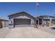 Exterior view of a single-story home with a two-car garage and a well-kept front yard at 6154 S Borego Rd, Gold Canyon, AZ 85118