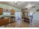 Open kitchen and dining area with tile flooring, sliding glass door and stainless steel dishwasher at 6154 S Borego Rd, Gold Canyon, AZ 85118