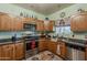 The kitchen offers wood cabinets, a stainless steel dishwasher, and a stainless steel range at 6154 S Borego Rd, Gold Canyon, AZ 85118