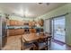 Open kitchen with warm wood cabinets, stainless steel appliances, and tile flooring at 6154 S Borego Rd, Gold Canyon, AZ 85118