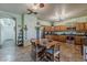 Spacious kitchen with wood cabinets, tile flooring, and a dining table with chairs at 6154 S Borego Rd, Gold Canyon, AZ 85118