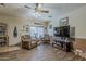 Comfortable living room featuring wood-look floors, ample seating, and a large window at 6154 S Borego Rd, Gold Canyon, AZ 85118