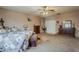 Bright bedroom featuring neutral walls, carpeting, ceiling fan and natural light at 6154 S Borego Rd, Gold Canyon, AZ 85118