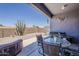 Inviting patio area with a table and chairs next to a hot tub, ideal for outdoor relaxation at 6154 S Borego Rd, Gold Canyon, AZ 85118