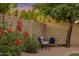 Outdoor patio area showing a comfortable chair, colorful plants, and a private backyard area at 630 W Saragosa St, Chandler, AZ 85225