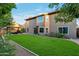 An expansive green lawn highlights this backyard that also includes a stone patio and lots of mature trees at 630 W Saragosa St, Chandler, AZ 85225