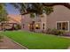 This backyard boasts a lush lawn, a pergola with outdoor seating and string lights, and mature landscaping at 630 W Saragosa St, Chandler, AZ 85225