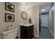 Stylish powder room featuring decorative mirror, accent lighting, and modern vanity at 630 W Saragosa St, Chandler, AZ 85225