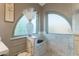 Bright bathroom showing walk-in shower with built-in seat and arched windows at 630 W Saragosa St, Chandler, AZ 85225