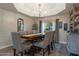 Well-lit dining room featuring decorative chair railing, hardwood floors, and a modern chandelier at 630 W Saragosa St, Chandler, AZ 85225
