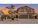 Charming two-story home with a two car garage, a well maintained landscape, and a large palm tree at 630 W Saragosa St, Chandler, AZ 85225