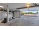 Well-lit garage with cabinets, storage space, and an open garage door showing the neighborhood at 630 W Saragosa St, Chandler, AZ 85225
