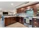 Beautiful kitchen with dark wood cabinets, stainless steel appliances, and an open layout at 630 W Saragosa St, Chandler, AZ 85225