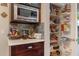 Kitchen pantry with built-in shelving and microwave providing ample storage for food and cooking appliances at 630 W Saragosa St, Chandler, AZ 85225