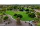 This aerial view highlights a well manicured neighborhood park, with mature trees, walking trails, and playground equipment at 630 W Saragosa St, Chandler, AZ 85225