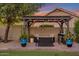 Outdoor patio with covered pergola with lights, outdoor furniture, brick flooring, and lush plants at 630 W Saragosa St, Chandler, AZ 85225
