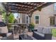 Outdoor patio area showing covered pergola with outdoor bar, cushioned seating, and outdoor decorations at 630 W Saragosa St, Chandler, AZ 85225