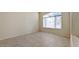 Neutral-toned bedroom featuring tile flooring, base molding and a large window for plenty of natural light at 6923 W Laredo St, Chandler, AZ 85226