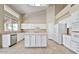 Bright kitchen featuring white cabinetry, tile flooring, large windows, kitchen island and modern appliances at 6923 W Laredo St, Chandler, AZ 85226