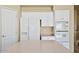Bright kitchen featuring white cabinets, tile flooring, kitchen island and a refrigerator at 6923 W Laredo St, Chandler, AZ 85226